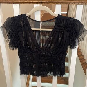 Worn only a few times free people black blouse. Super cute and flattering on.